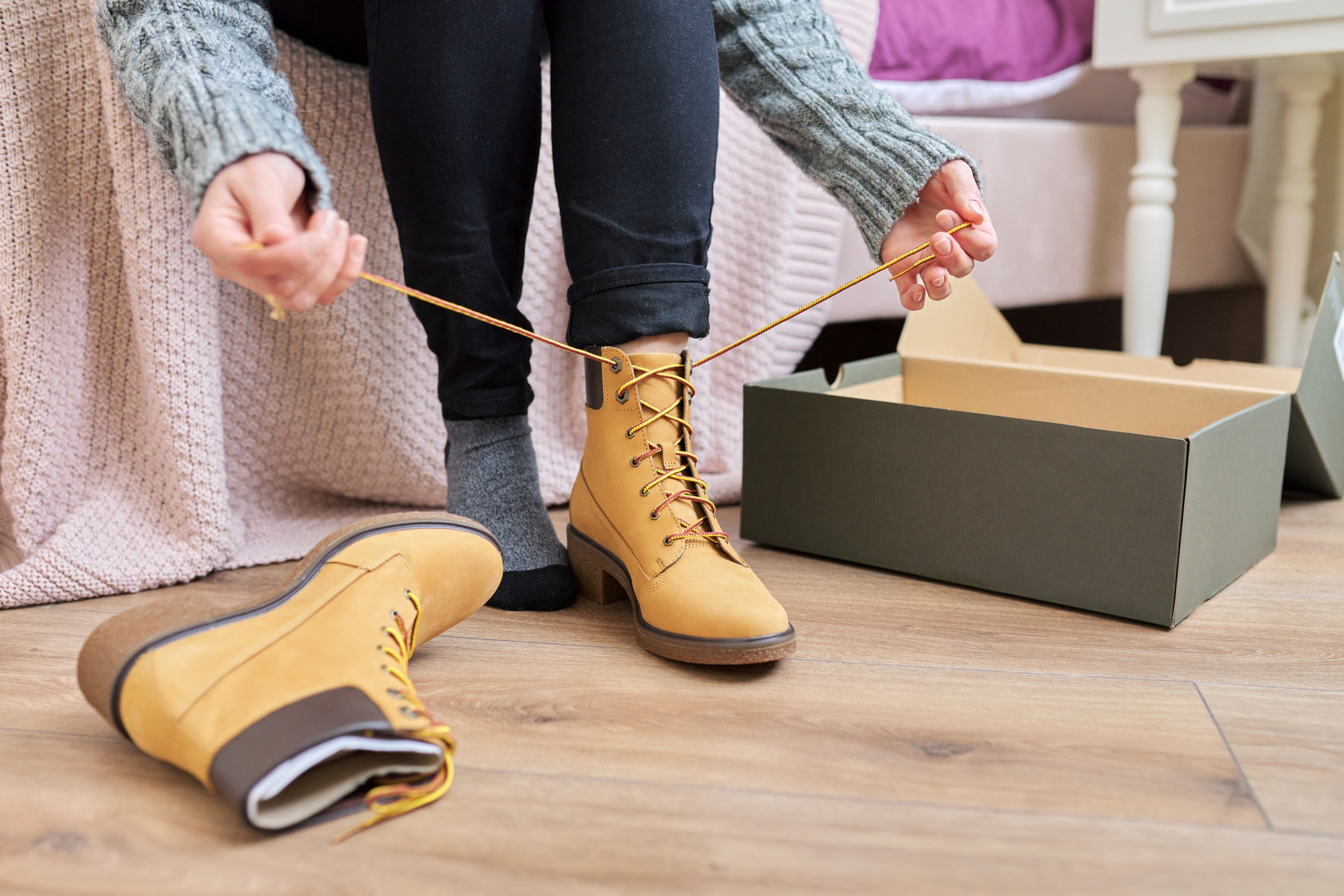 Autumn winter season, new shoes, close-up woman shoeing warm boots Autumn winter season, new shoes, close-up woman shoeing warm boots